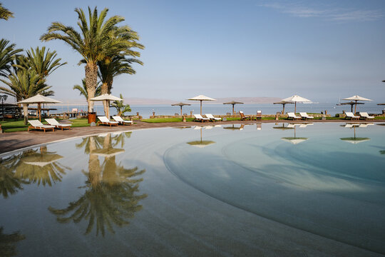 Paracas, Peru - 1 December 2025: Swimming pool at the La Hacienda Bahia, hotel by the beach in Paracas, Peru