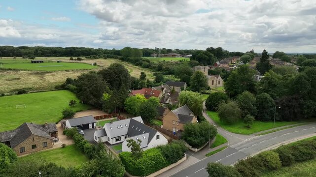 Aerial View of Suburban Village Houses and Country Road in Barton Seagrave Northamptonshire England