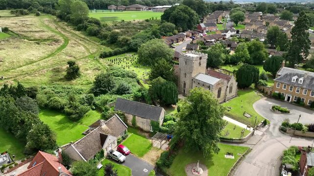 Aerial Close Up of Historic Village Church Tower and Curving Streets in Barton Seagrave Northamptonshire