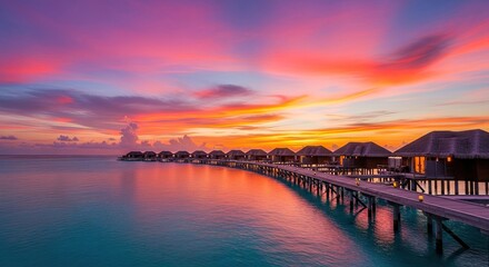 Fototapeta premium Luxury overwater bungalows at sunset in a tropical resort