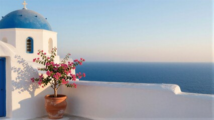 Fototapeta premium Blue-domed church pink flowers white walls overlooking the sea.
