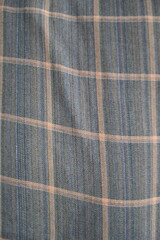 Fototapeta premium Close-Up Blue Plaid Fabric Texture With Orange Stripes — Woven Textile Pattern For Fashion And Decor