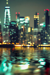 Fototapeta premium Nighttime cityscape viewed from the water with city lights reflected on the surface. vertical frame