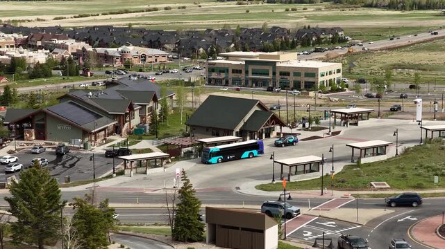Aerial of bus stop and commercial buildings near Park City Utah in spring