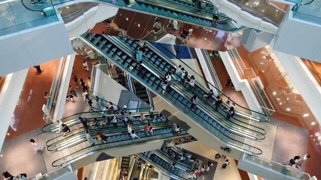Large crowd of people moves upwards on escalator in modern commercial or transportation hub. group persons in shopping mall. Time lapse man woman person traffic. department store shop. urban lifestyle