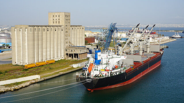 La Goulette, Tunisia - May 7, 2026: Seaport with a cargo ship moored next to a grain elevator in the port of La Goulette, Tunisia on May 7, 2026