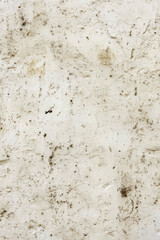 Fototapeta premium Dirt and grime cover a section of white wall, often used in construction or renovation scenes. vertical frame