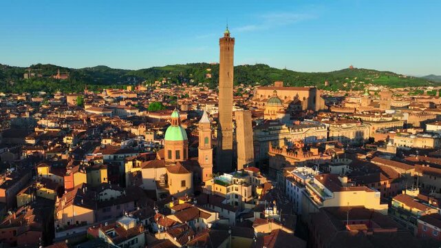 Bologna sunrise drone view, orbiting shot of historic old town of Bologna. Aerial view of medieval towers Le Due Torri and cathedral at sunset