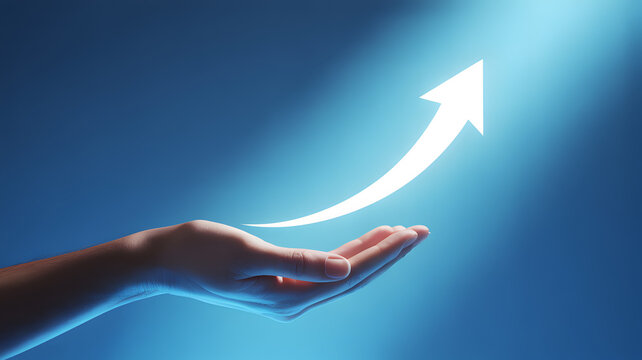 Hand holding a glowing upward arrow symbolizing growth and success during a bright spotlight