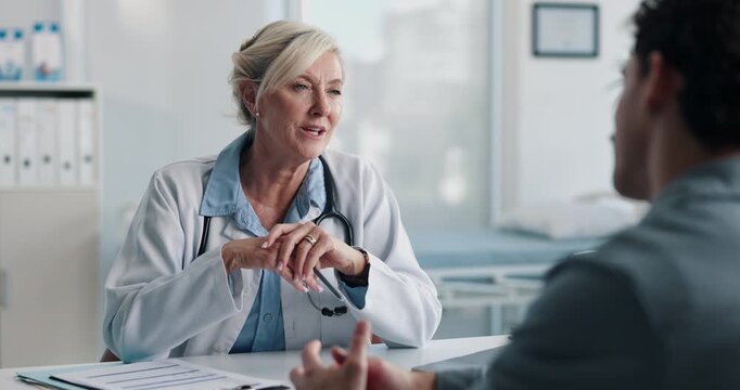 Healthcare, doctor or consulting with man in clinic for medical advice, treatment options or help. Checkup, happy professional and talking to patient for health feedback, diagnosis or follow up care