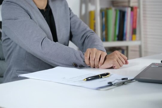 Hand, businesswoman, and wrist and arm pain from typing on a laptop, orthopedic injuries, or health risks. Muscle problems due to stress, fibromyalgia, and arthritis.