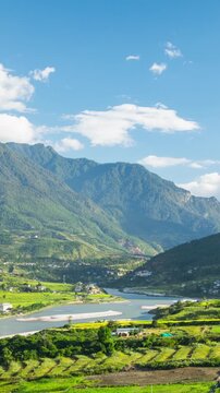 Time lapse of clouds moving over the rice paddies and the Punakha Valley in Bhutan.