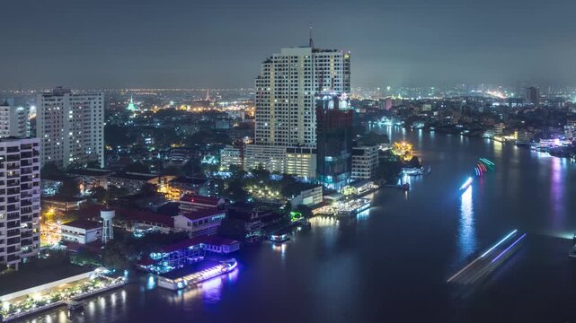 Time lapse of boat traffic on the Chao Phraya River in Bangkok Thailand at night.
