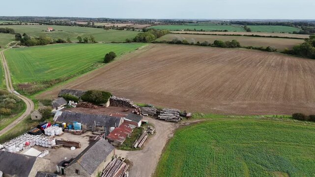 Aerial Overview of Working Farm Complex and Fields in Northamptonshire English Countryside