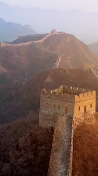 Flying over the Great Wall of China at sunrise. Vertical Video,