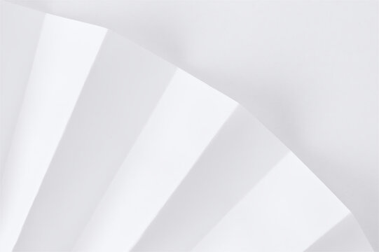 Folded white paper with geometric lines and shadows, minimalist abstract background for creative design.