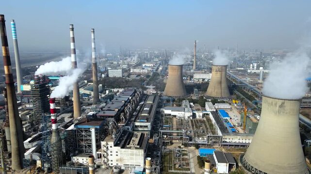 Large industrial power plant with cooling towers and smokestacks