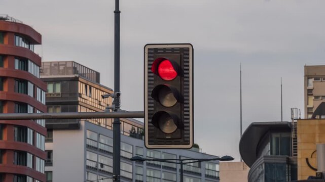 Close-up view of traffic light changing from red to green, modern city crossroad, traffic control, downtown urban background, modern architecture glass buildings