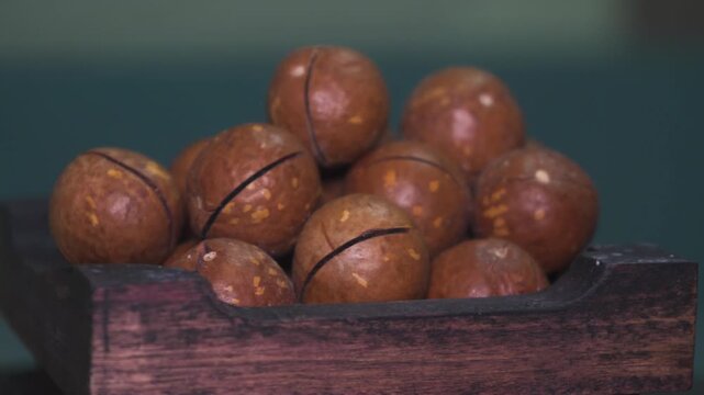 Brown Macadamia Nuts in Wooden Crate