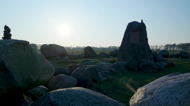 Tracking shot revealing an ancient megalithic stone circle at sunset