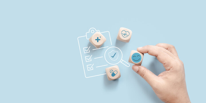 Wooden cube healthcare management concept with smiling medical icons, wellness checklist, heart monitoring, medication support, digital health planning, soft blue background, modern healthcare system