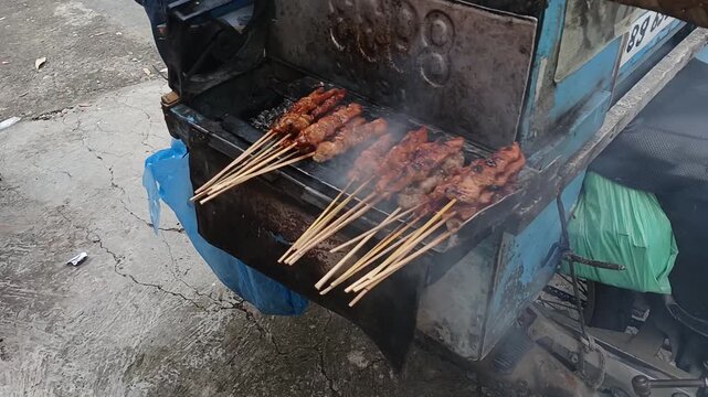 Indonesian Chicken Satay Grilling on Traditional Charcoal Grill