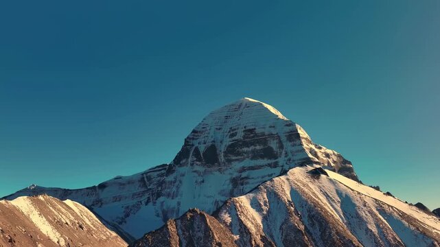 Snow-covered Mount Kailash peak under clear blue sky in Tibet