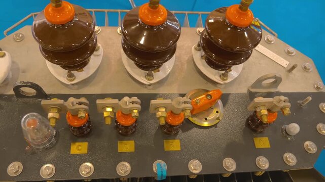 Ceramic insulators in high-voltage equipment are presented at the exhibition. Closeup. Shot in motion 
