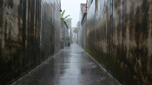 Narrow Alleyway in an Asian Town Under Heavy Rain, with Water Droplets Creating Ripples on the Wet
