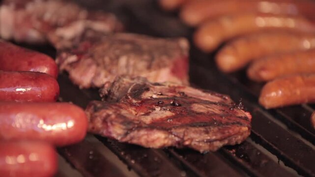 A close-up view of a piece of cooked pork chop on a grill. The chop is surrounded by cooked chorizos placed side by side in an aesthetic manner.