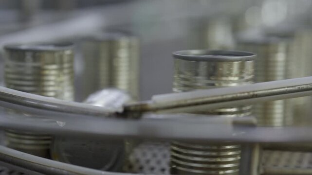 Food factory automated production line, Metal can conveyor line industrial packaging production machine closeup, metal can production line with cylindrical container factory, industrial machinery