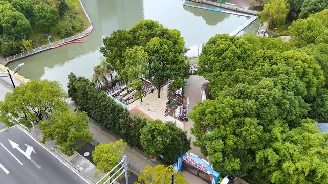 Green Urban Park with Lake and Tree Lined Walkways