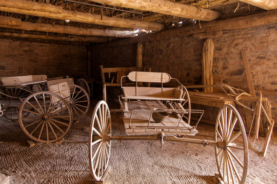 Vintage wagon stored inside a rustic barn