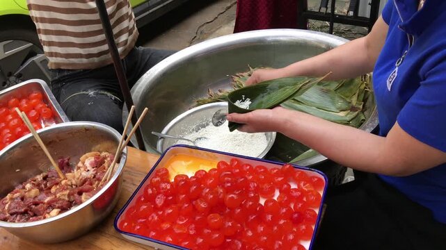 Street Food Vendor Preparing Sticky Rice Dumplings with Pork and Salted Egg Yolks