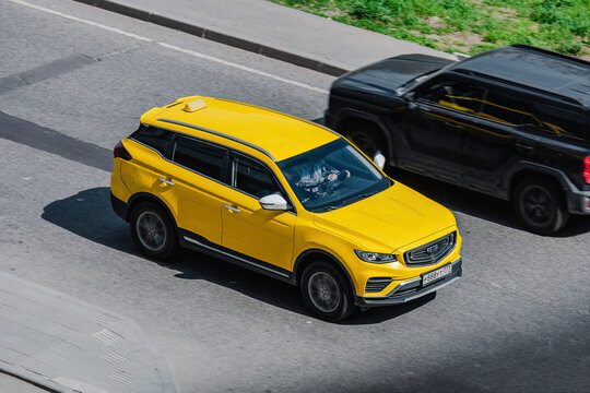 Moscow, Russia - 7 may 2026: City taxi car rushes down a city street. Yellow SUV in motion blur