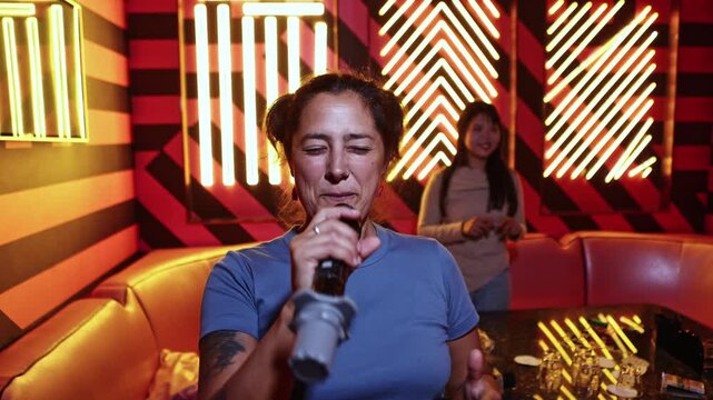 Happy smiling woman singing karaoke with friends