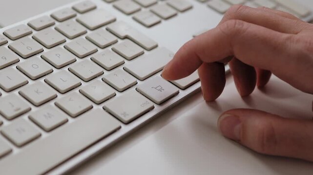 Close-up of a finger pressing the shopping cart key on a computer keyboard isolated on white background