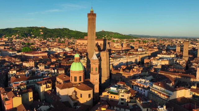 flying around two medieval towers in Bologna at sunrise