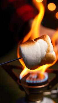 Gourmet corn bread on spoon above glowing campfire