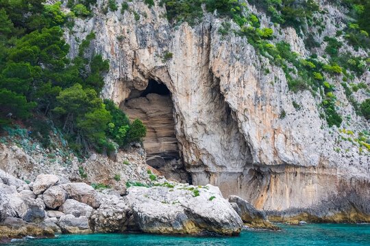 Capri island rock formations featuring sea cave