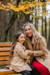 Fototapeta premium mother and daughter walking in the park in autumn