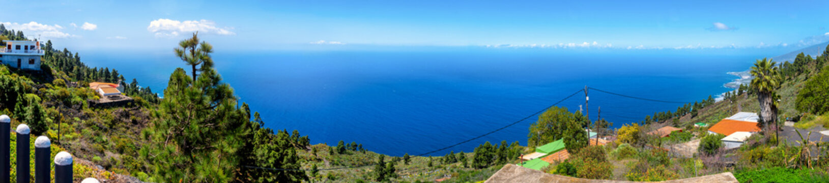 Panoramic view from Mirador El Charco over Atlantic Ocean, coast and green slopes on La Palma.