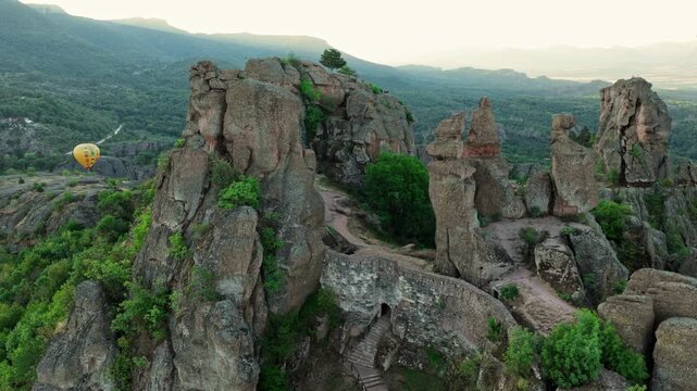 Scenic aerial view Belogradchik Rocks Bulgaria sunrise golden hour lighting mountain panorama summer tourism destination unique rock formations drone shot.