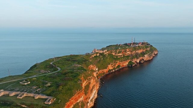 Bulgaria Black Sea Kaliakra Narrow Peninsula Aerial Drone Red Cliffs Wind Turbines Golden Sunset Spring Hazy Horizon Nature Travel Tourism Landmark Geography Heritage Concept Horizontal