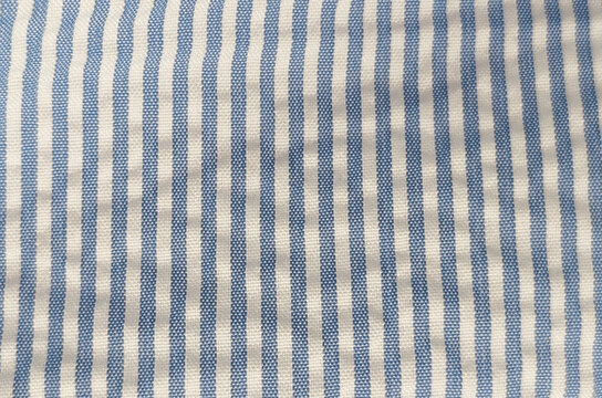 macro texture of blue and white striped seersucker fabric