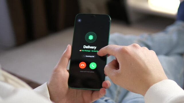 Close-up of a hand reaching to pick up a phone call from Delivery. Professional mobile UI with parcel tracking icon. Ideal for videos about logistics, shipping services, and online shopping customer