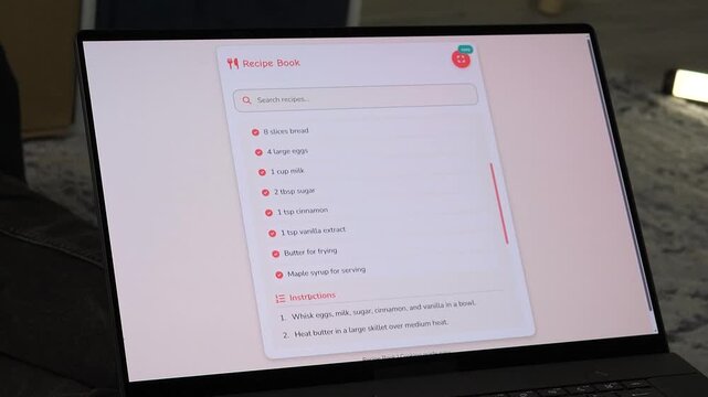 Cinematic close-up of a laptop screen showing a digital recipe for French Toast. User scrolls through ingredients and instructions. Perfect for home cooking, food blogging, and digital lifestyle