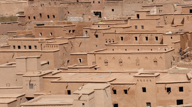 Traditional adobe village architecture with layered earthen homes in a desert landscape.