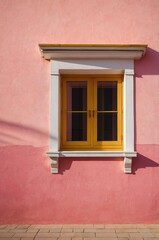 Fototapeta premium Portrait of yellow window on pink wall background 