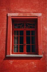 Obraz premium Portrait of red window on red wall background 